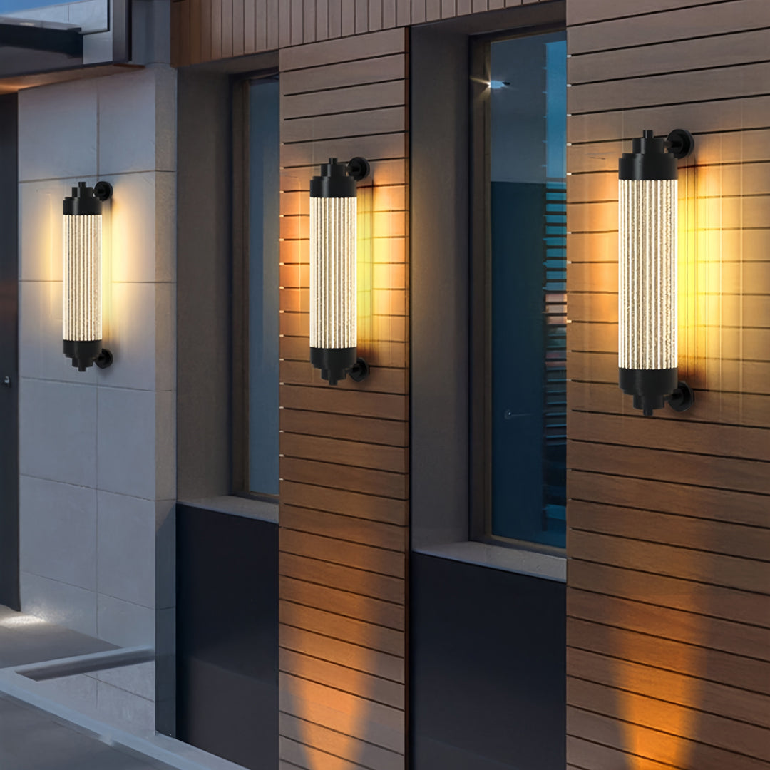 Vertical outdoor wall lighting LED fixtures illuminating a modern exterior corridor with soft warm light.