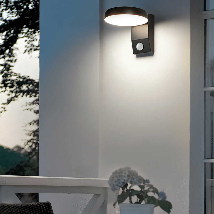 Outdoor wall lights with motion sensor illuminating a balcony area at dusk.
