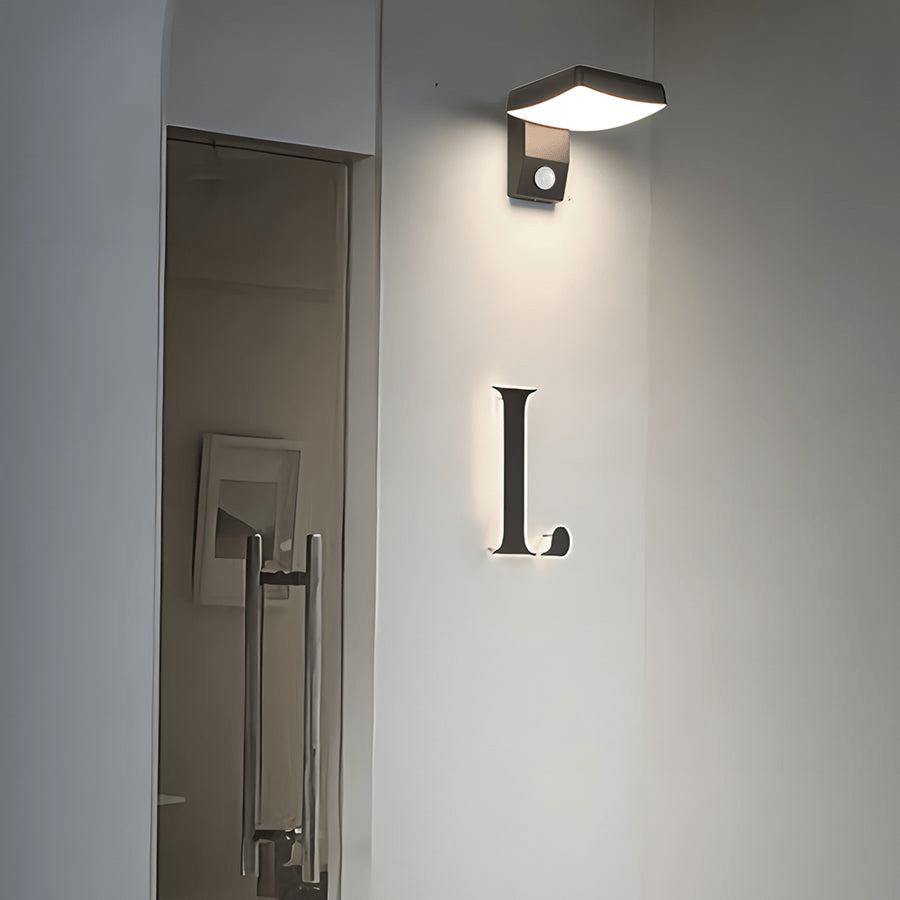 Outdoor wall lights with motion sensor mounted beside a door, casting a bright glow.