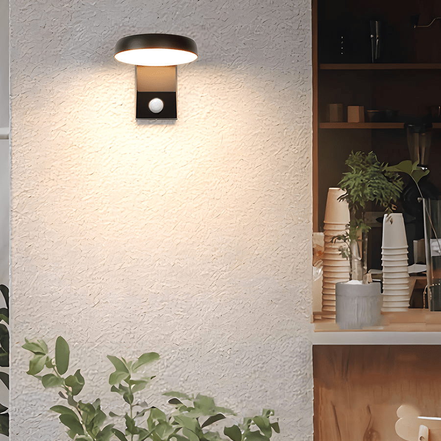 Outdoor wall lights with motion sensor providing security lighting for a white exterior wall.