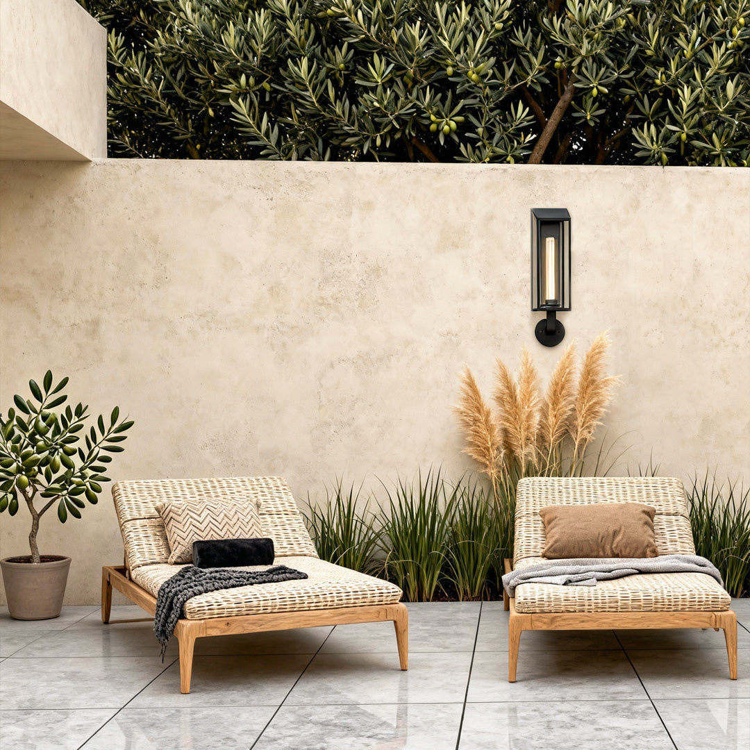 Outdoor wall mount light fixture illuminating a cozy patio seating area with warm vertical lighting.