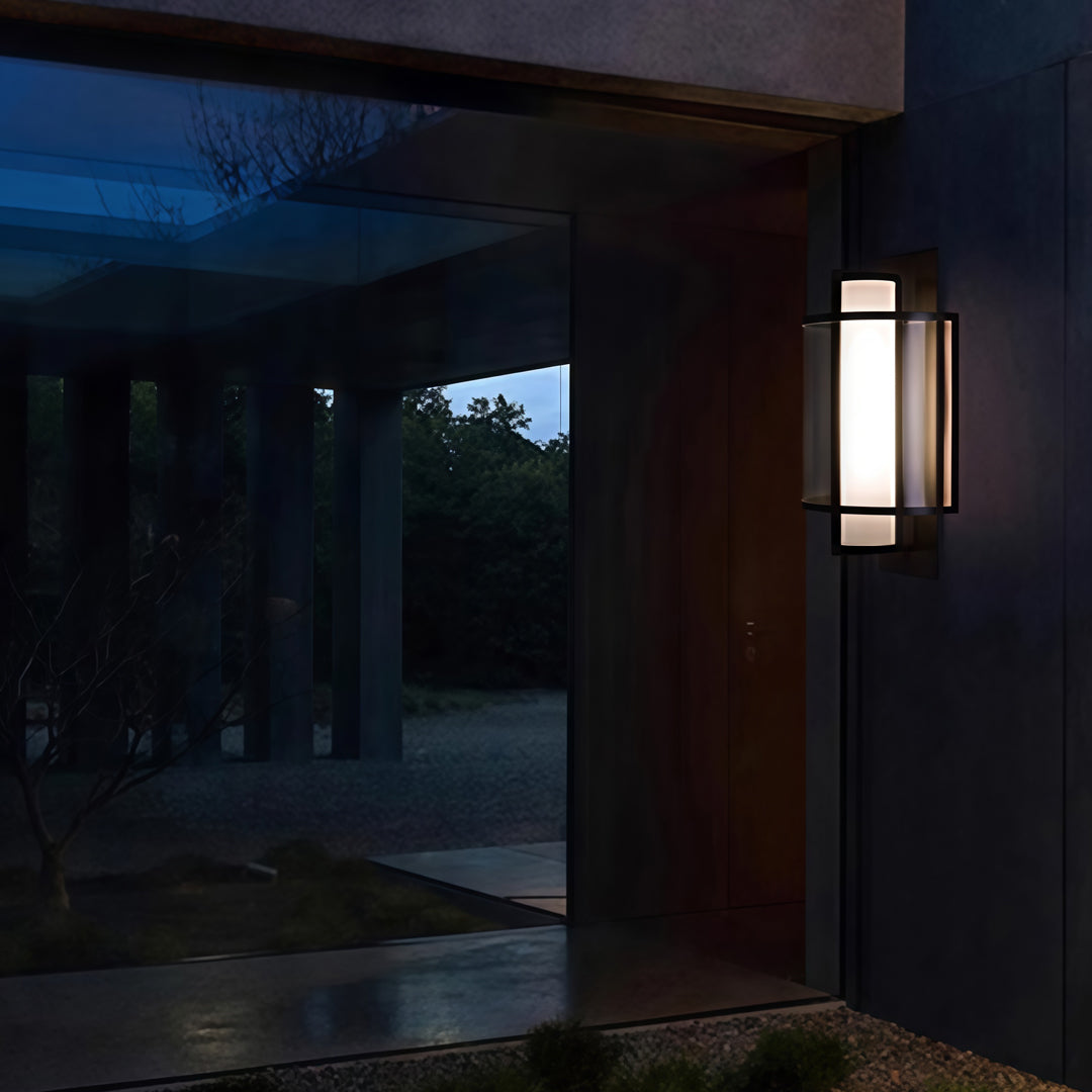 Modern exterior space featuring sleek outdoor wall mounted lighting illuminating walkway at dusk.