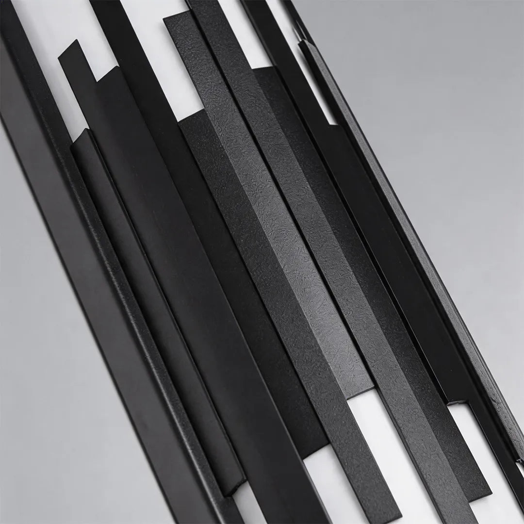 Outdoor wall sconce with decorative black metal bars and textured finish detail