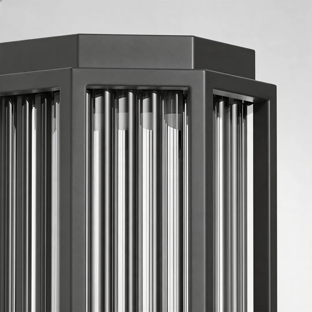 Outdoor wall sconce with black metal frame and vertical slatted design detail