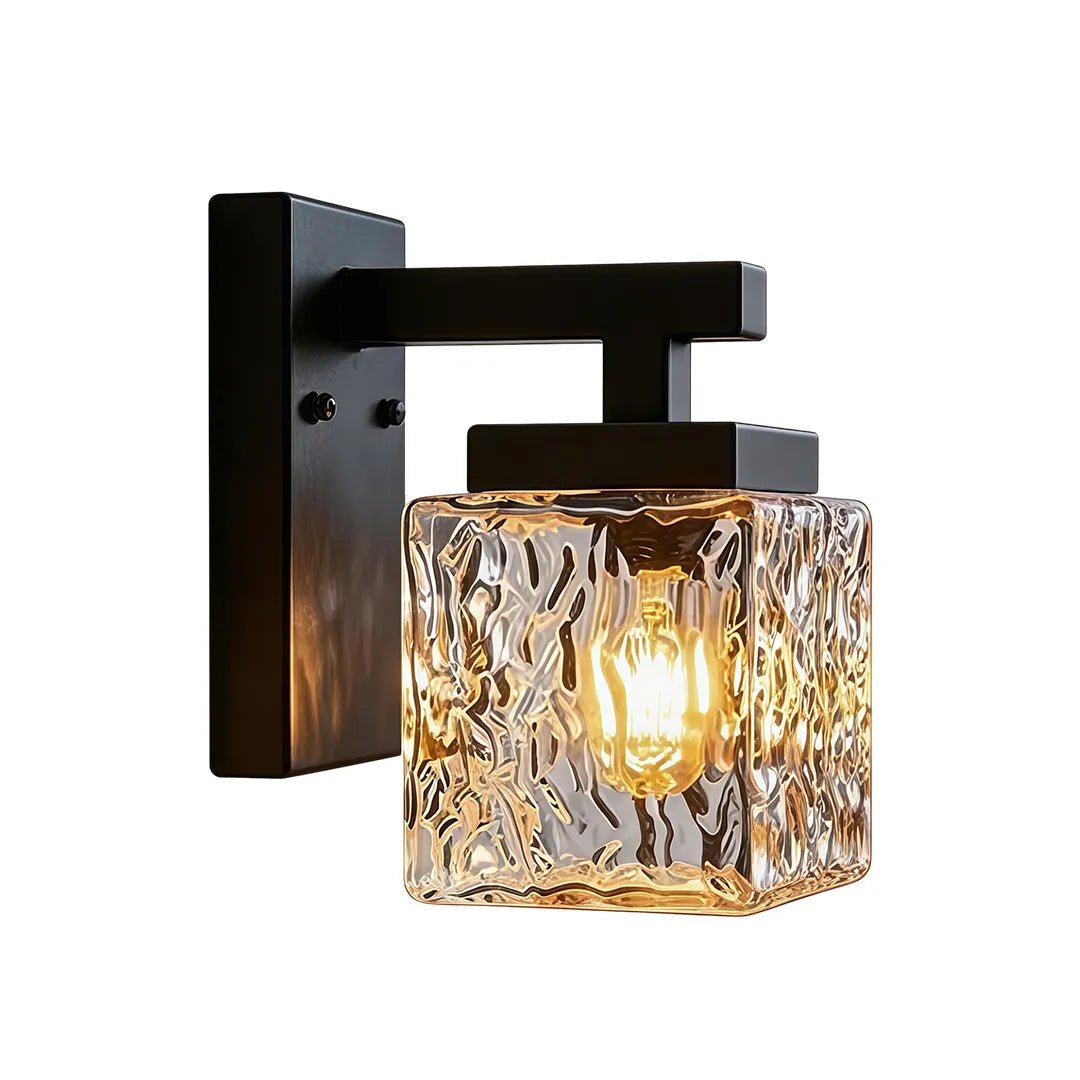 Outdoor wall sconce with clear textured glass cube and black metal mounting arm