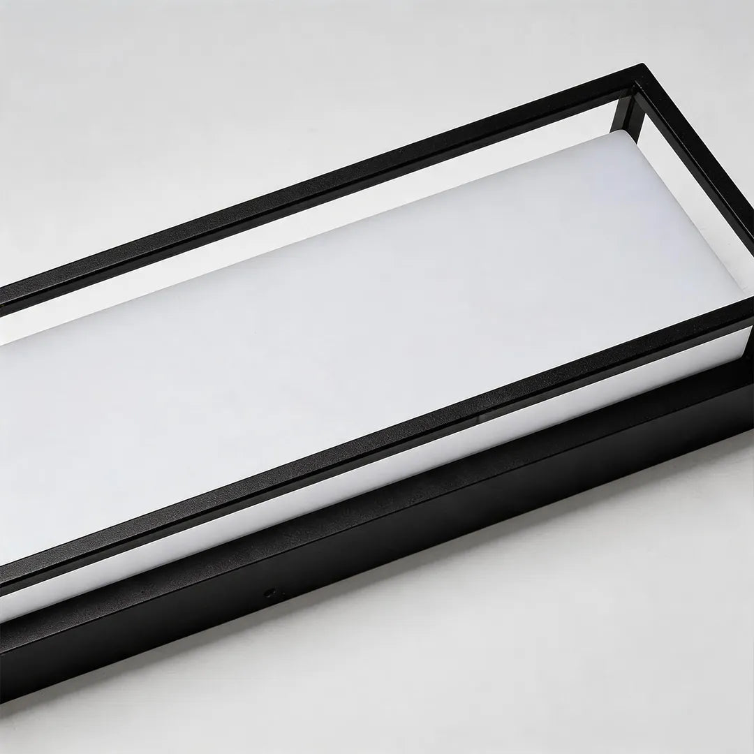 Outdoor wall sconce with frosted glass diffuser and black metal frame detail