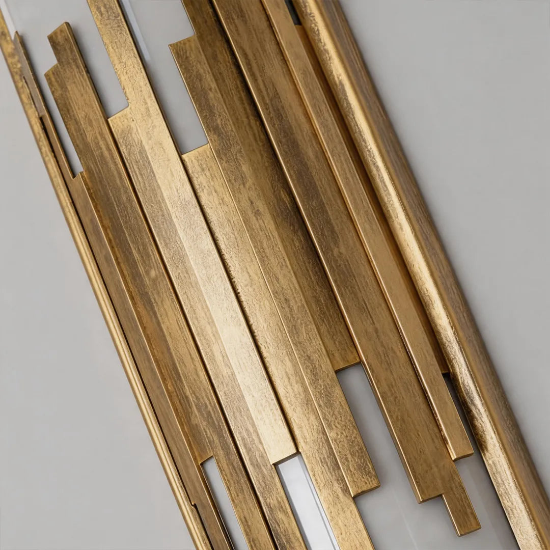 Outdoor wall sconce with brushed gold metal bars and decorative finish detail