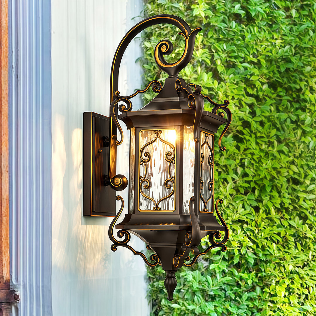 Outdoor Wall Sconce Light on beige wall surrounded by lush green vines.