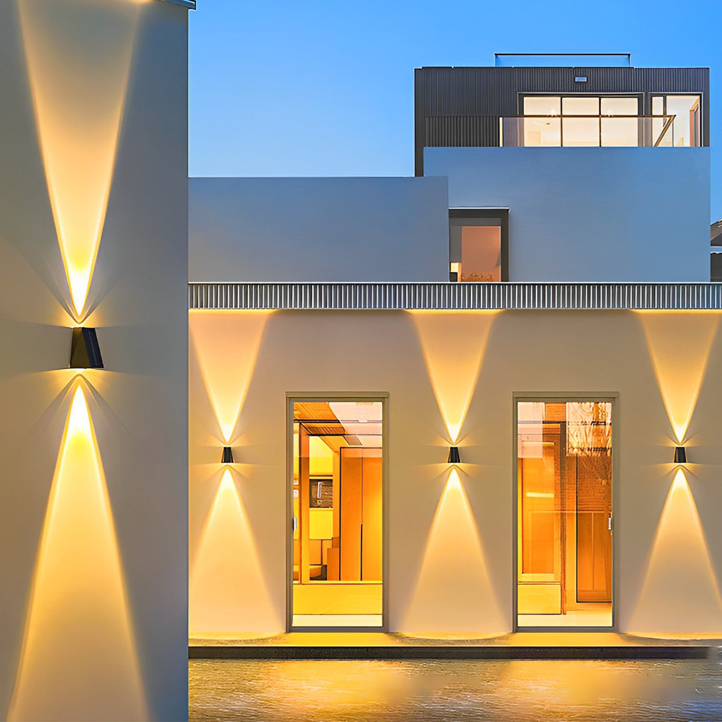Outdoor wall sconce up and down lighting enhancing a contemporary house facade at dusk.