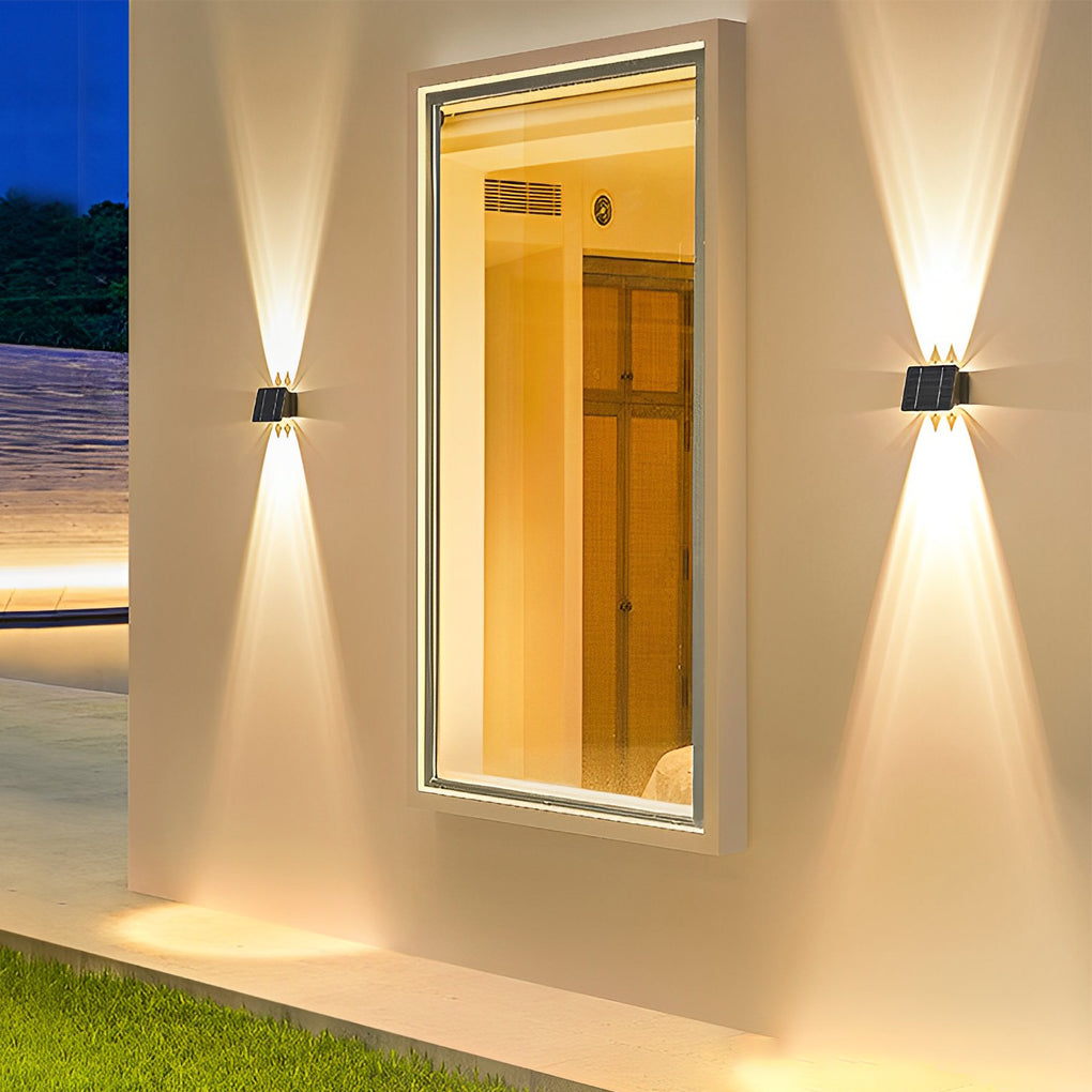 Outdoor wall sconce up and down lighting beside a mirror, casting warm light on a white wall.