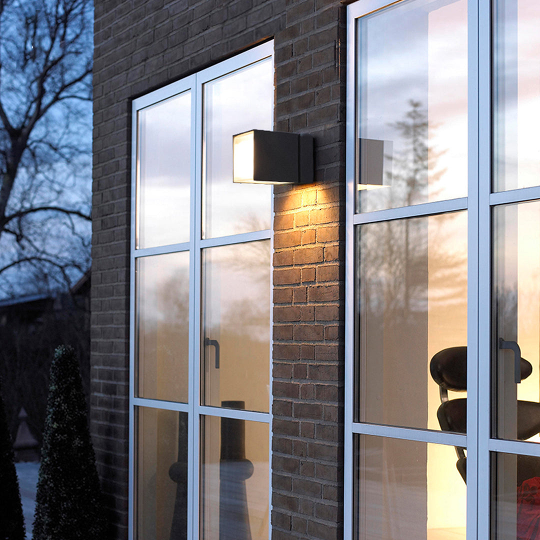Contemporary architectural facade with sleek outdoor wall up lighting fixtures creating vertical light accents.