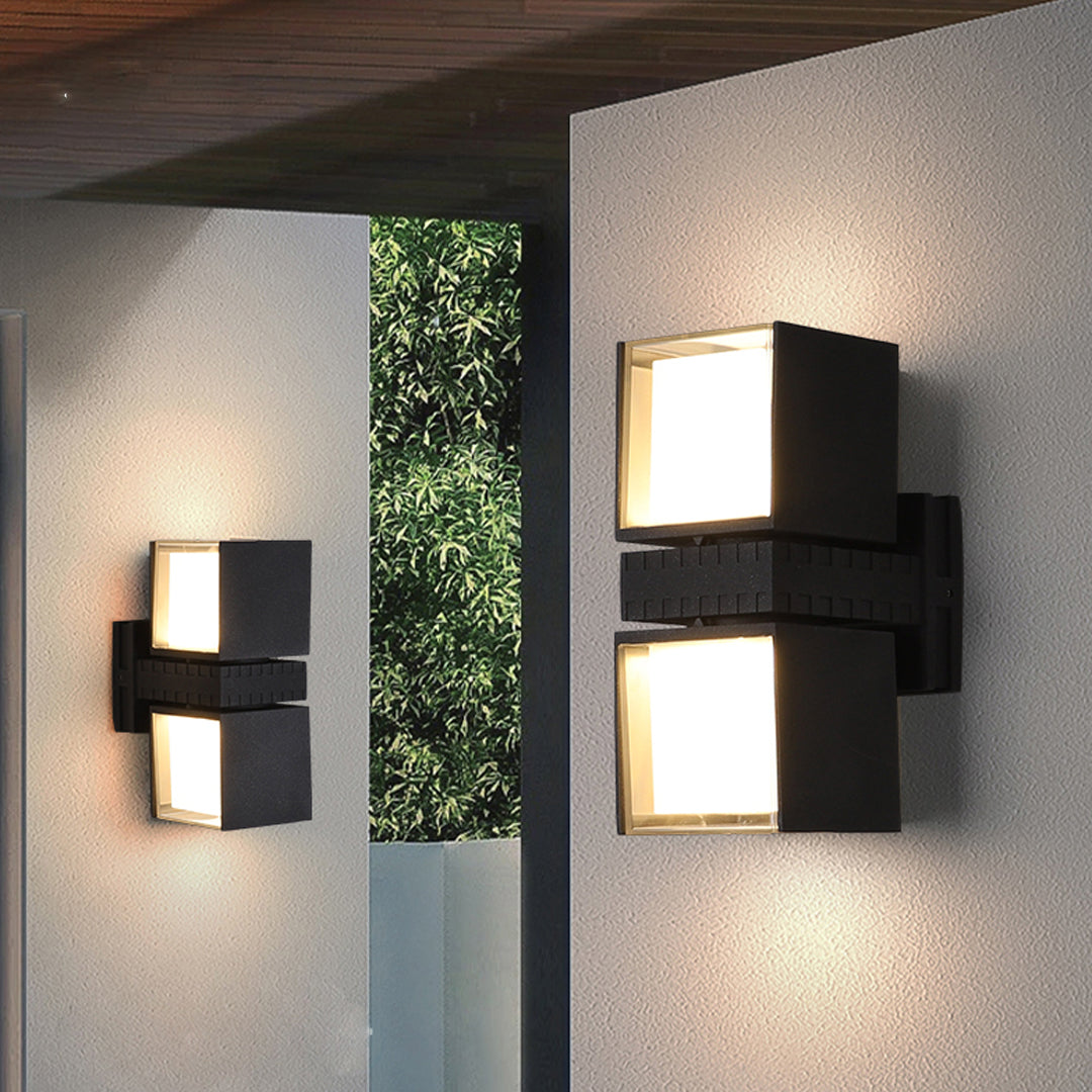 Warm exterior ambiance created by modern outdoor wall up lighting fixtures installed along a textured wall surface.