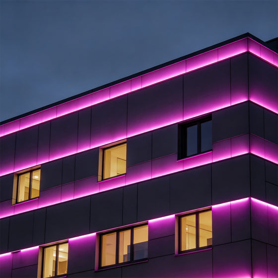 Outdoor wall wash lighting installed on modern commercial building with warm architectural glow.
