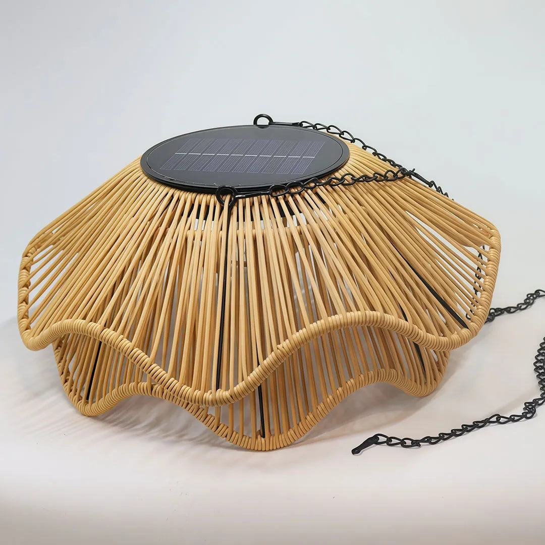 Outdoor woven pendant light detail showing the curved rattan shade and integrated solar panel.
