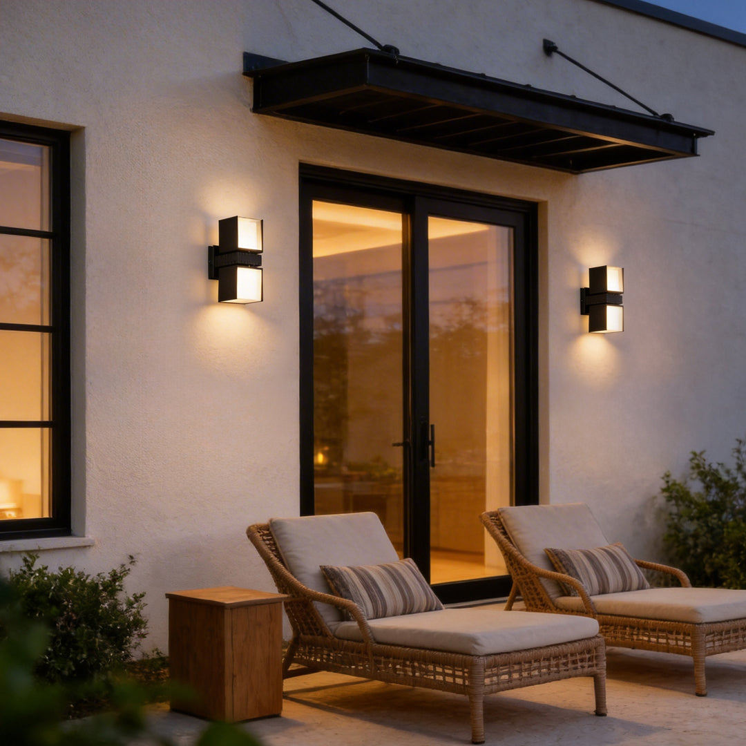 Outside up down wall lights with a modern design, mounted beside a patio seating area.
