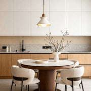 Oval bulkhead wall light installed beside a modern stone exterior door at dusk.