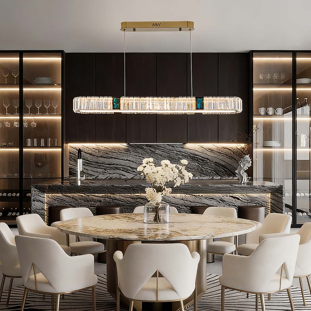 Oval crystal chandelier providing elegant illumination above a marble dining table.