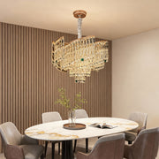Modern dining area with oval crystal pendant chandelier in gold finish.
