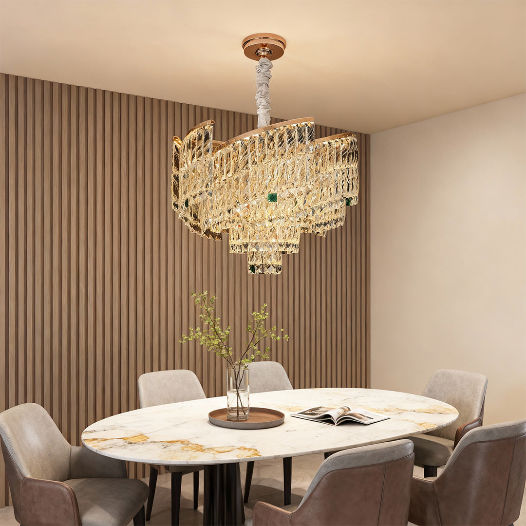 Modern dining area with oval crystal pendant chandelier in gold finish.