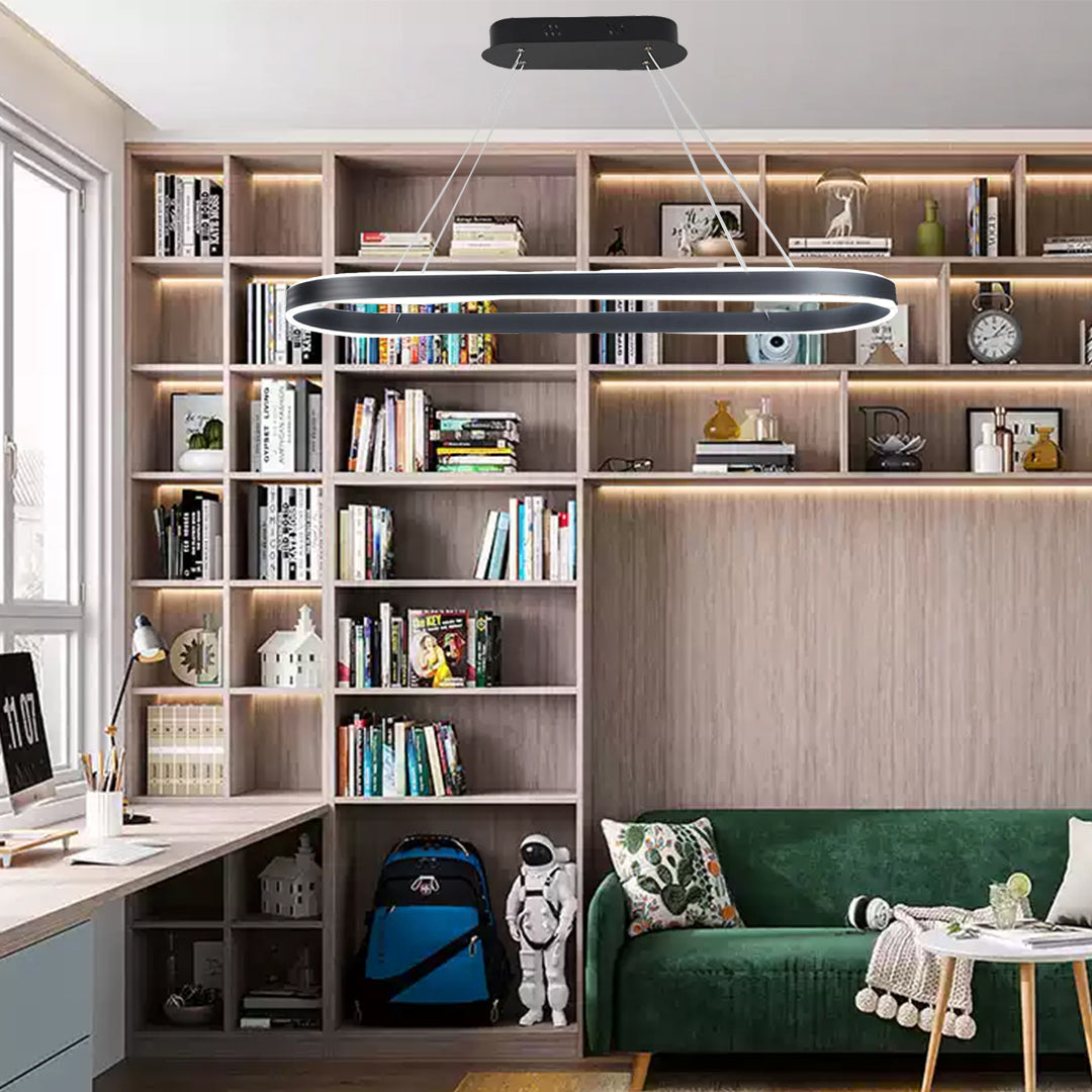 Sleek oval LED pendant light used in a modern study room with warm wood cabinetry.