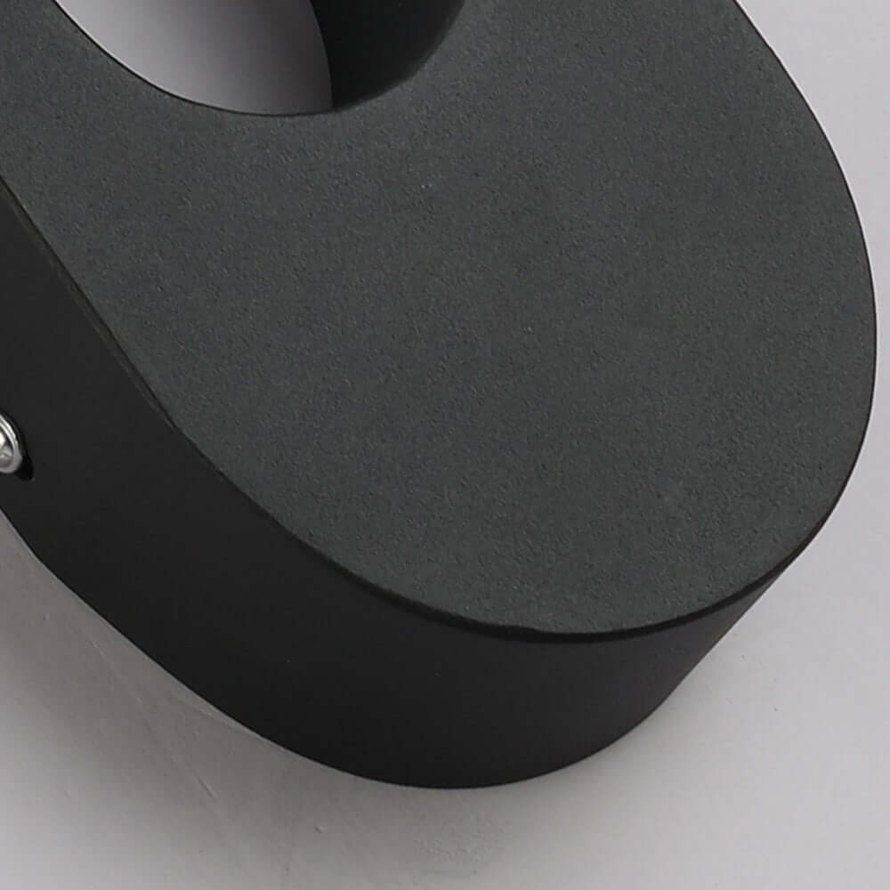 Elegant black oval LED wall sconce with soft LED light, providing a minimalistic yet stylish design for modern homes.