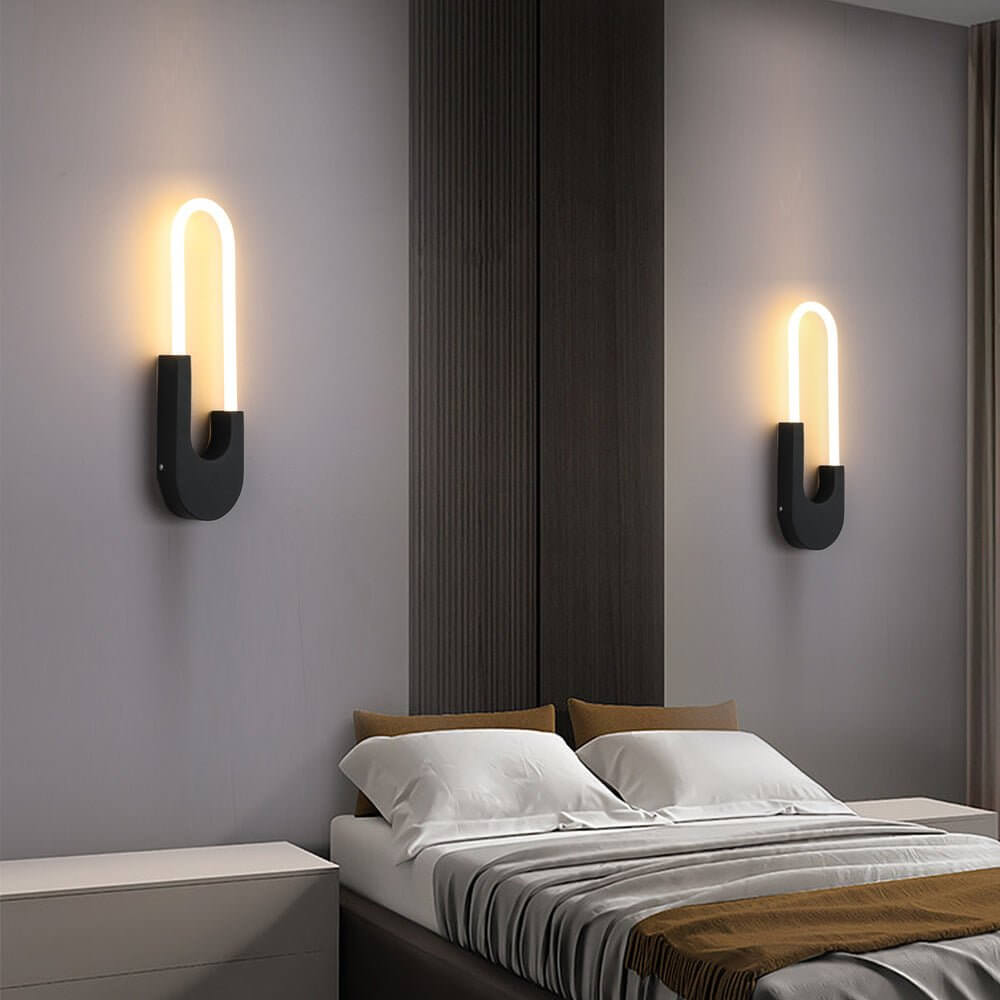 Modern oval LED wall sconce illuminating a living room with soft, warm light, enhancing the decor and ambiance.
