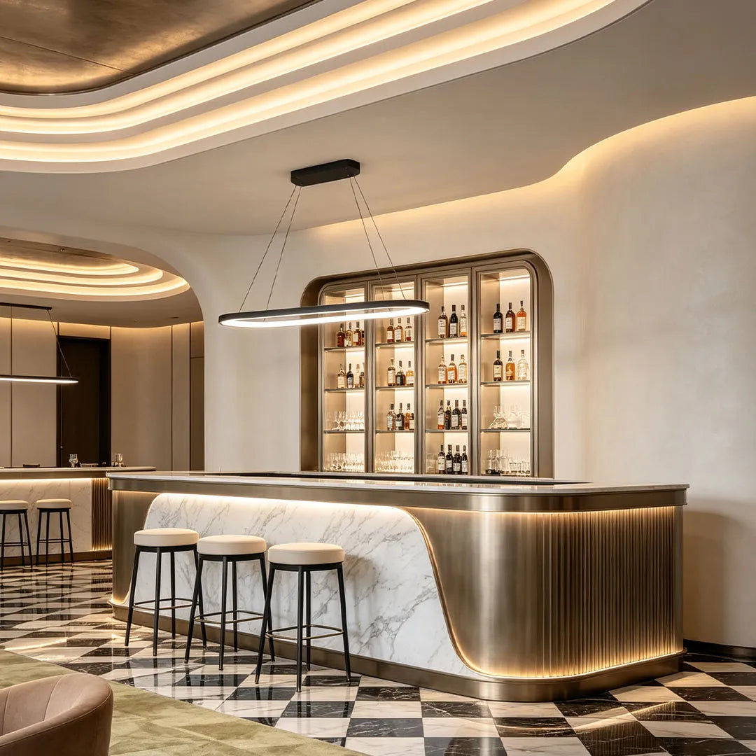 Oval pendant light illuminating a curved bar counter in a contemporary lounge with warm architectural lighting.