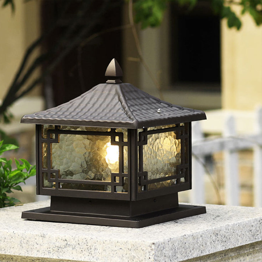 Pagoda-style outdoor garden pillar light with traditional design installed in natural garden setting