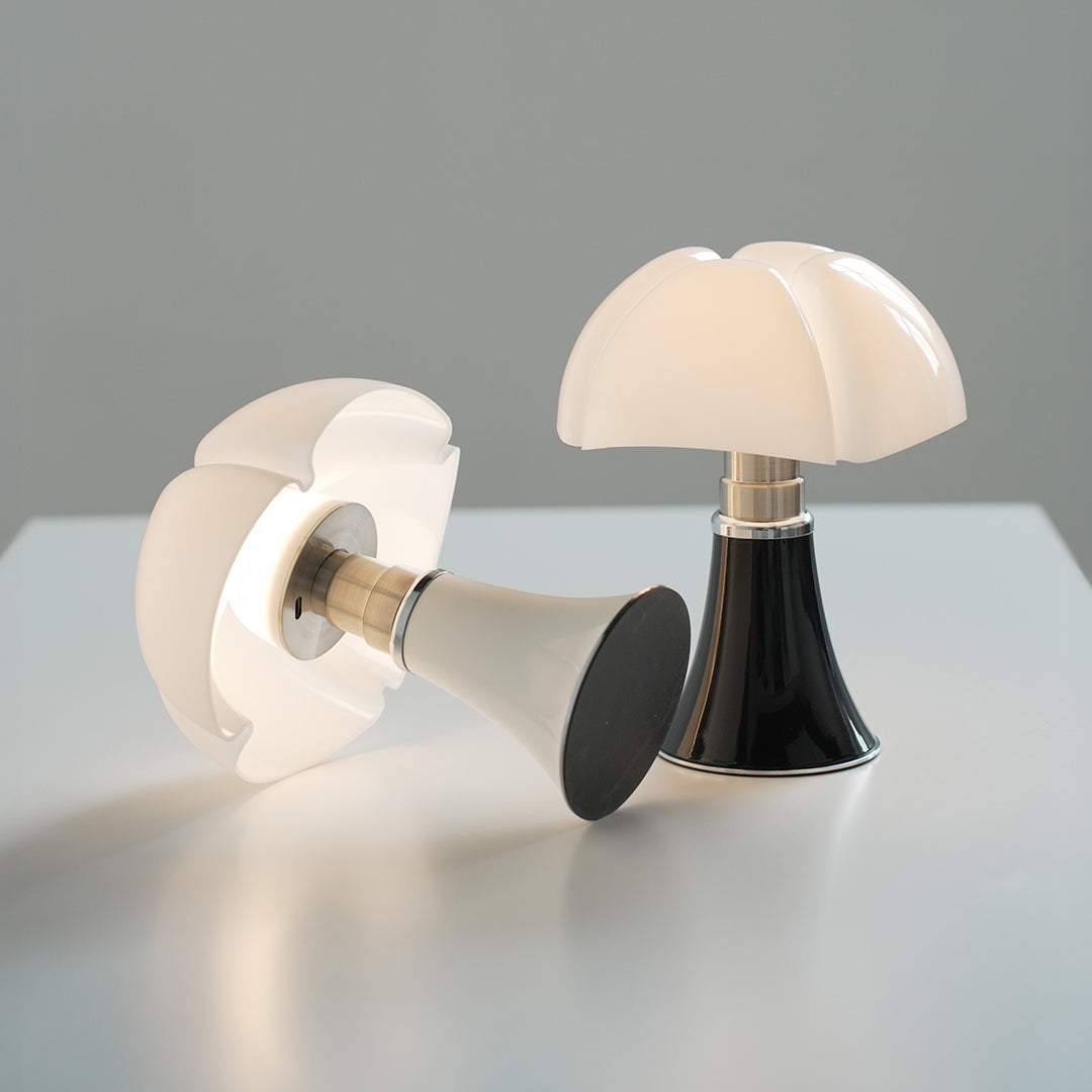 Pair of Bauhaus mushroom table lamps in white and black, placed on table.