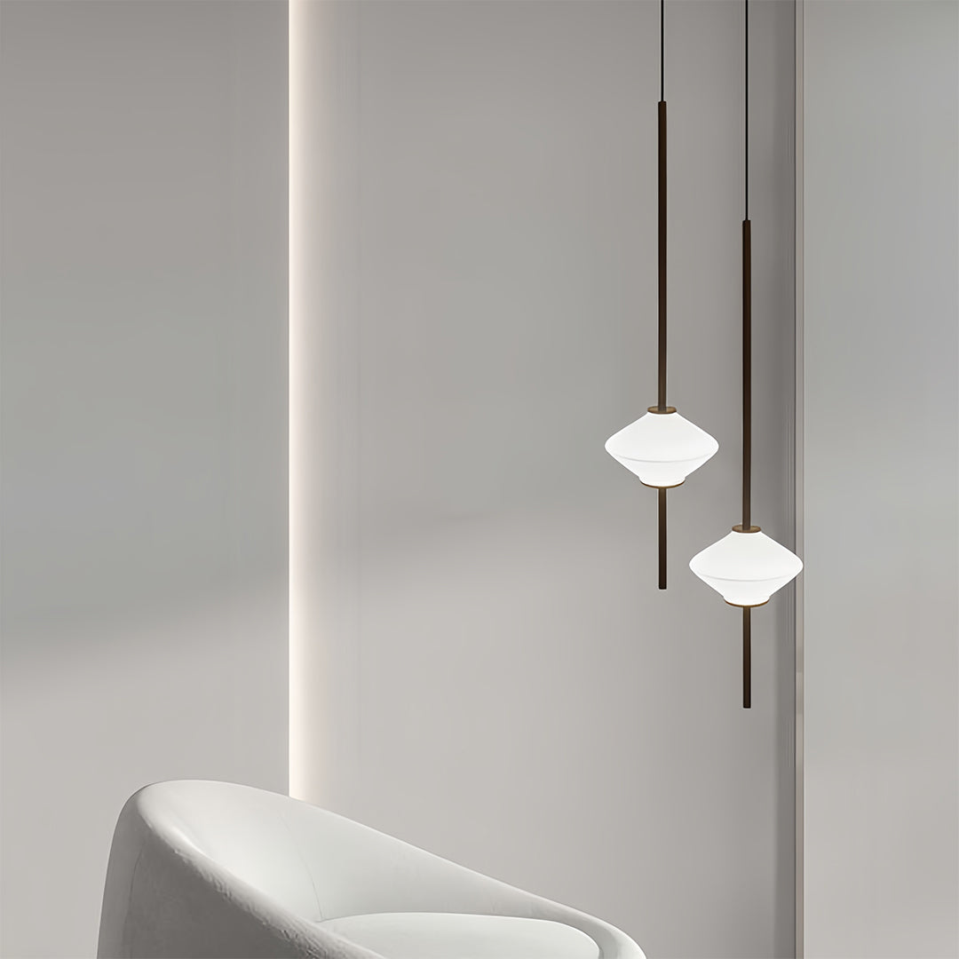 Elegant bedside pendant lights with white geometric shades installed beside contemporary bathtub