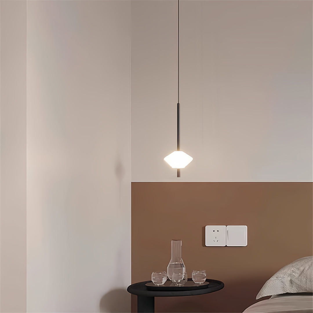 Pair of bedside pendant lights creating symmetry on textured neutral wall surface
