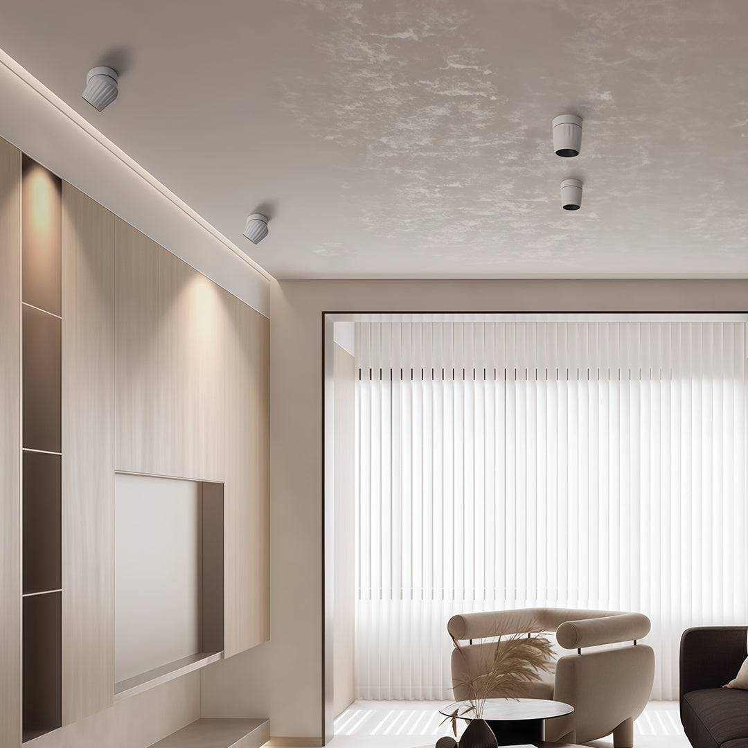 Pair of rotating spotlights brightening elegant living room with white built-in cabinetry and modern furniture