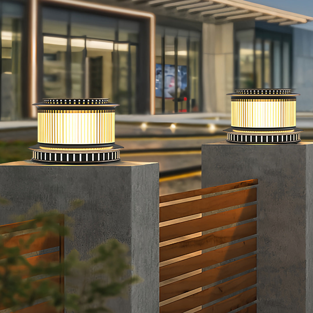 A pair of stainless steel pillar lights enhancing the entryway of a modern home, creating a stylish and safe environment.