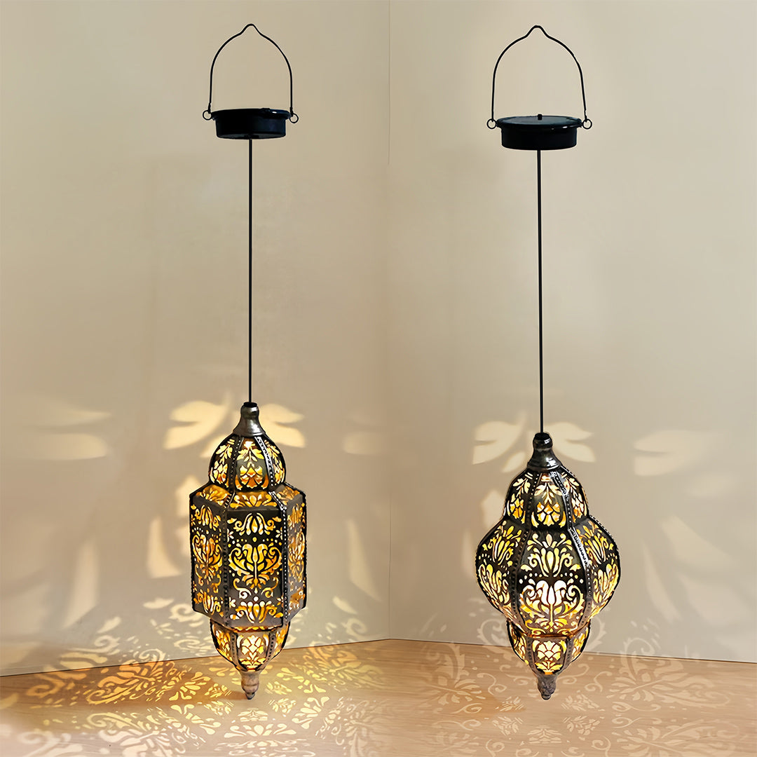 Pair of outdoor moroccan lanterns (teardrop and cylindrical) showing projection effect with warm solar LED light.