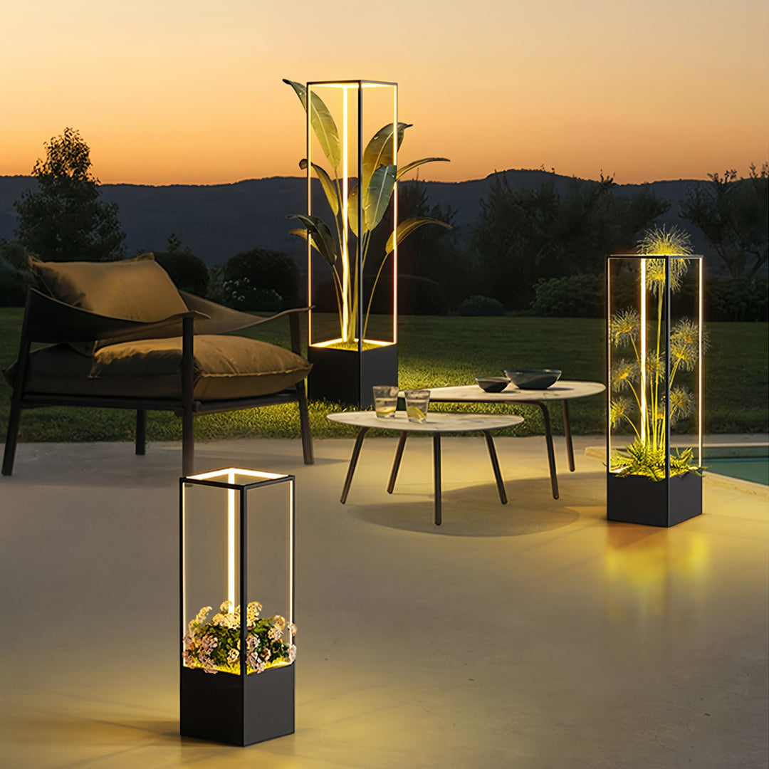 Pair of tiered square floor lamps illuminating a contemporary sunset deck, serving both as lighting and decorative plant stands.