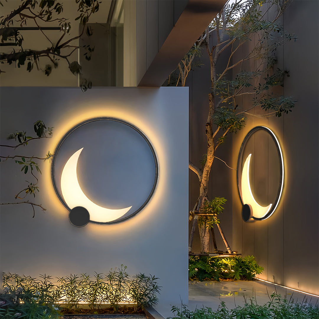 Pair of decorative outdoor wall lights on blue and tan walls creating sculptural lighting effect