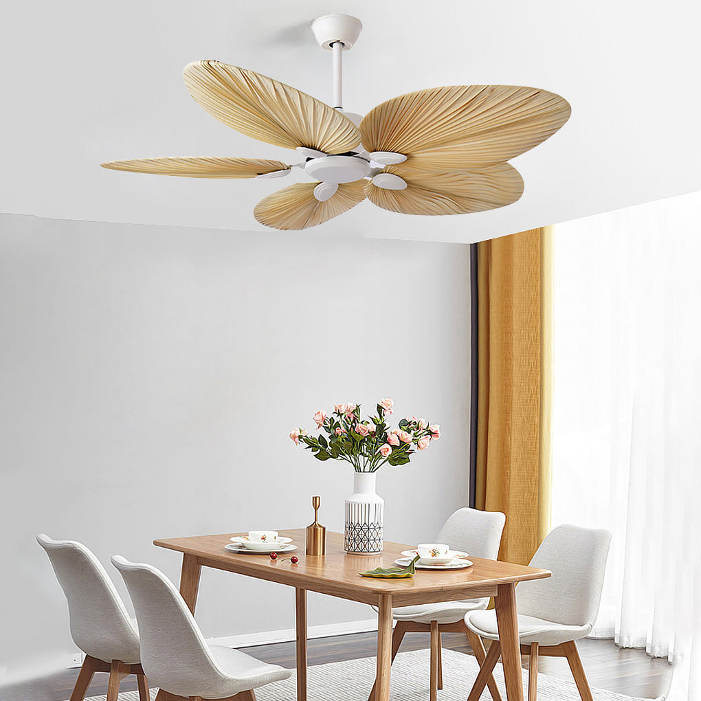 Palm Frond Ceiling Fan installed in a dining room, showcasing natural palm leaf blades and a white motor creating a relaxed tropical interior atmosphere.