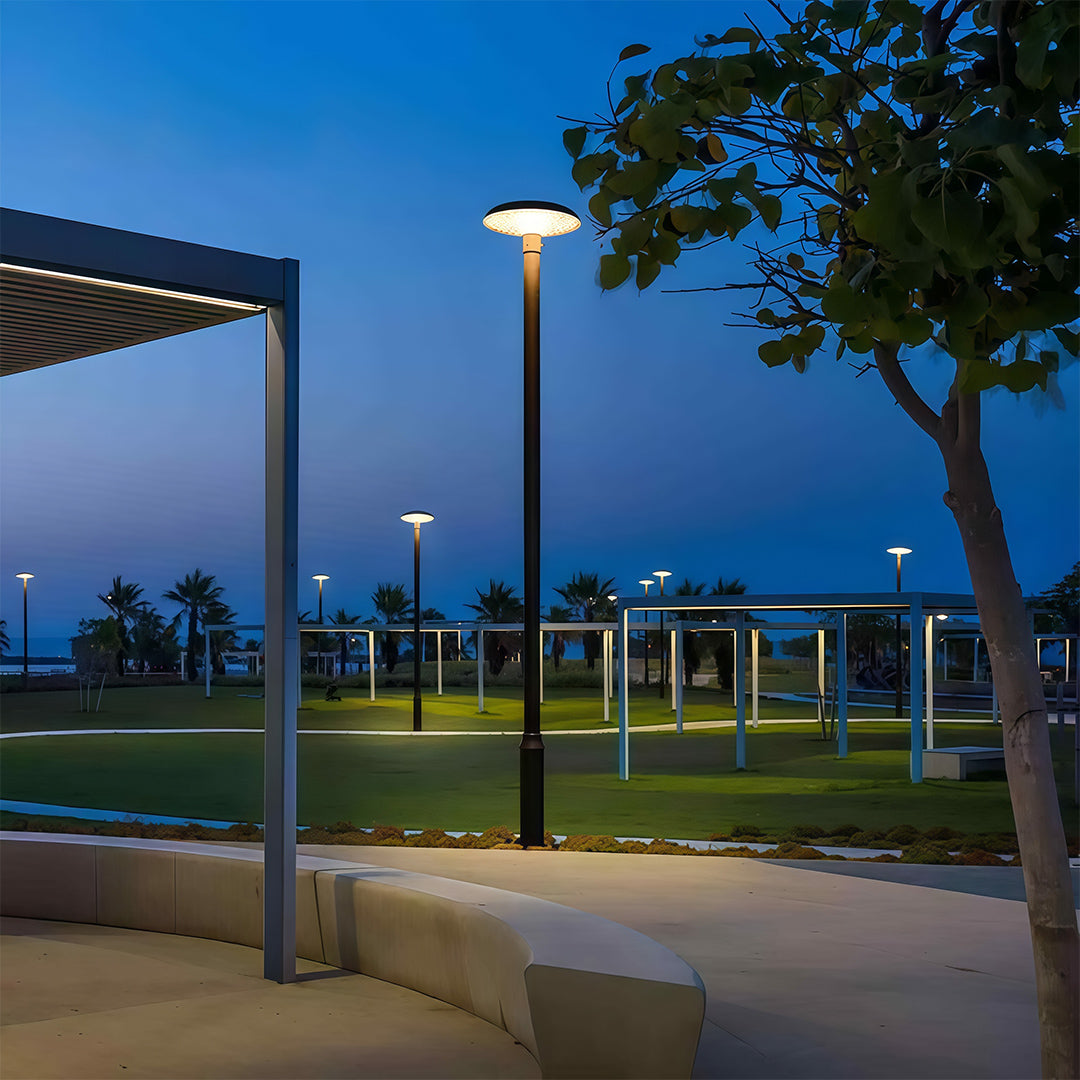 Streetlight casting warm light over a peaceful park trail, ideal for nighttime strolls.