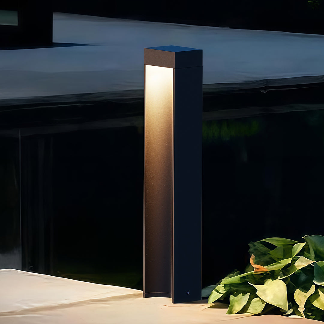 Path light stake installed along a garden pathway, providing warm and inviting illumination.