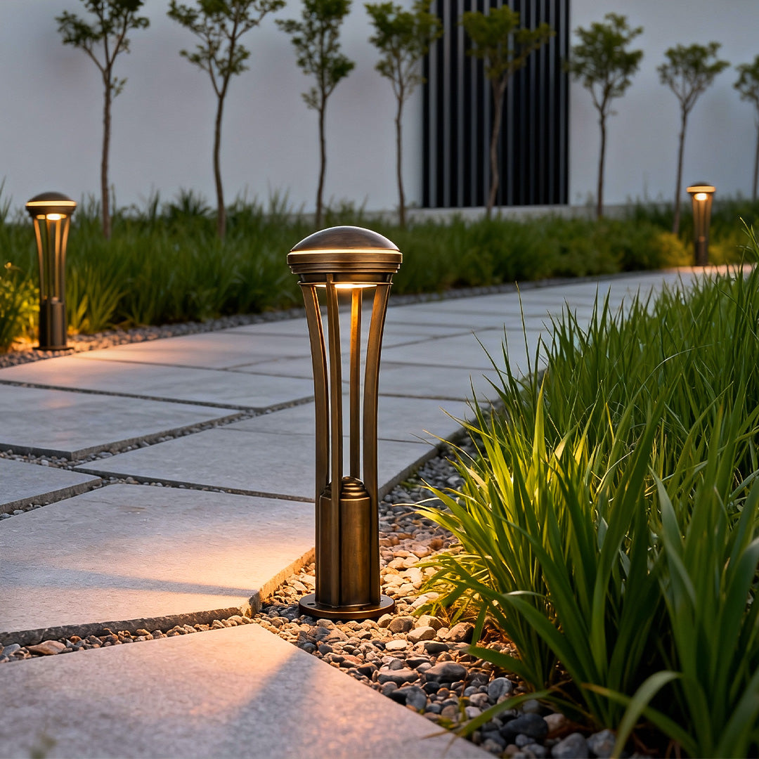 Outdoor path light stakes lining a stone pathway, creating even lighting and guiding steps through a modern yard.