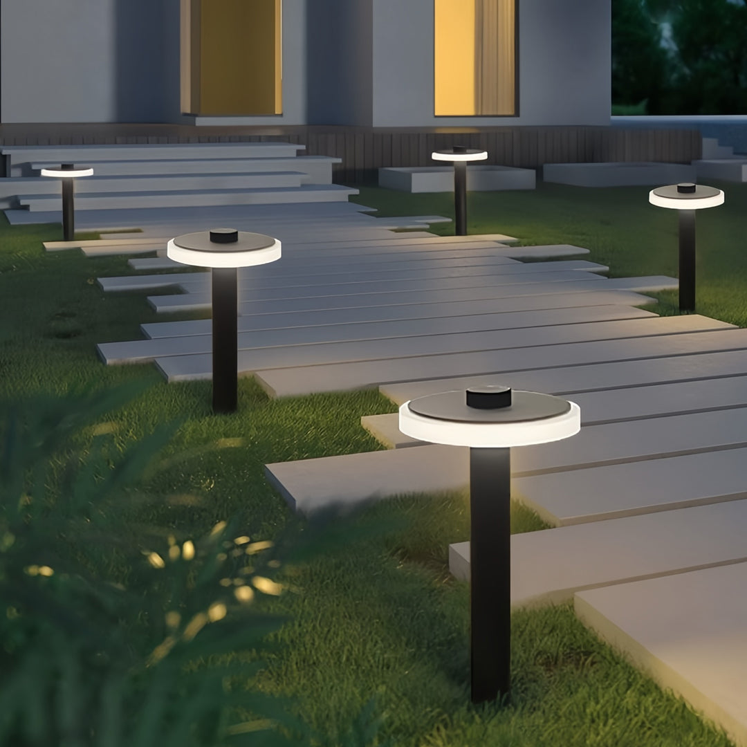 Outdoor garden path lighting outdoor fixtures illuminating a modern walkway with warm downward light.