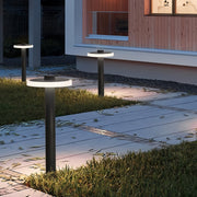 Modern dual-height path lighting outdoor fixtures providing ambient lighting along a stone pathway.