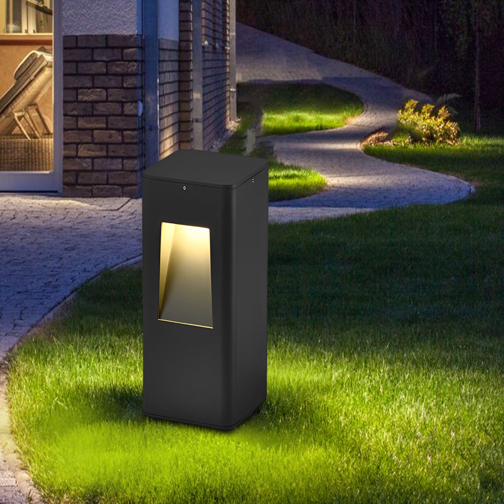 Pathway bollard lights enhancing the safety and ambiance of a curved garden path with green lawns.