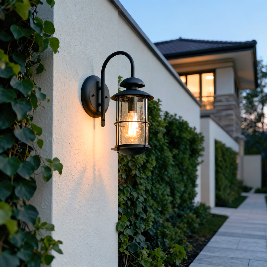 Outdoor wall mount light fixtures lining a pathway on a modern home exterior.