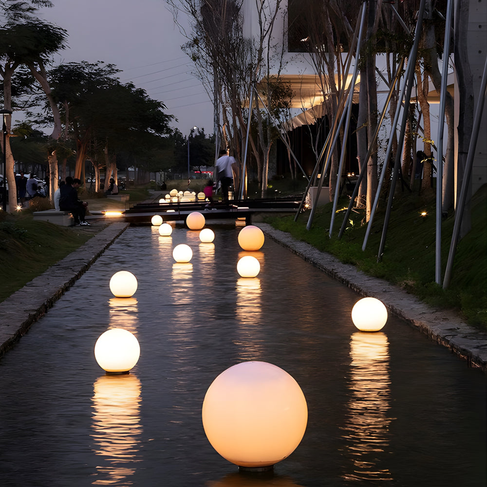 Silver Metal Table Lamp round landscape lighting spheres lined along pathway providing warm ambient illumination in evening garden setting