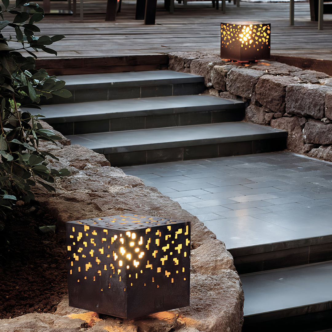 Black outdoor lantern lights used along stone steps, adding warm guiding illumination in outdoor pathways.