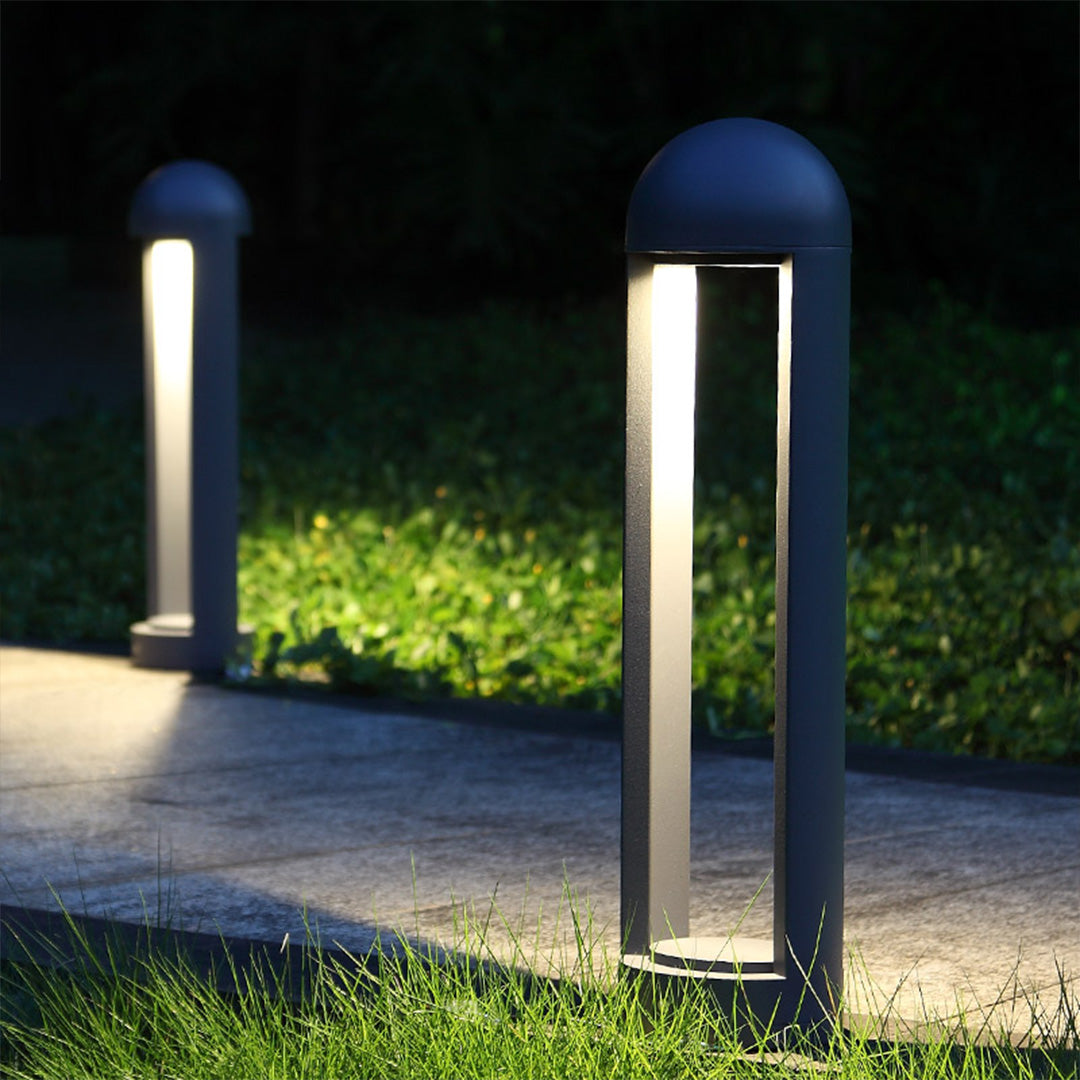 Modern cylindrical lights providing pathway illumination with clean vertical light output
