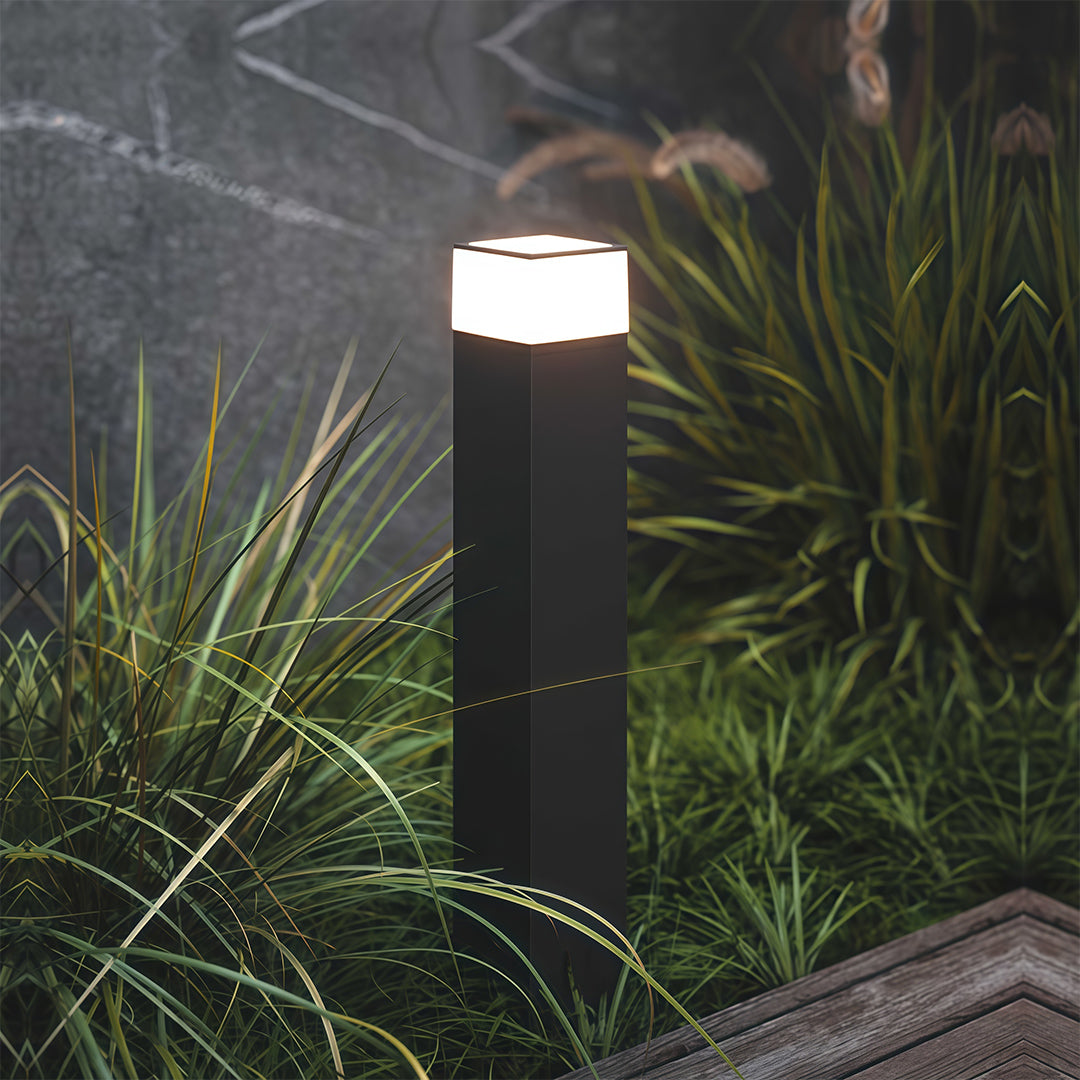 Pathway yard light along a gravel pathway, offering stylish and functional lighting.