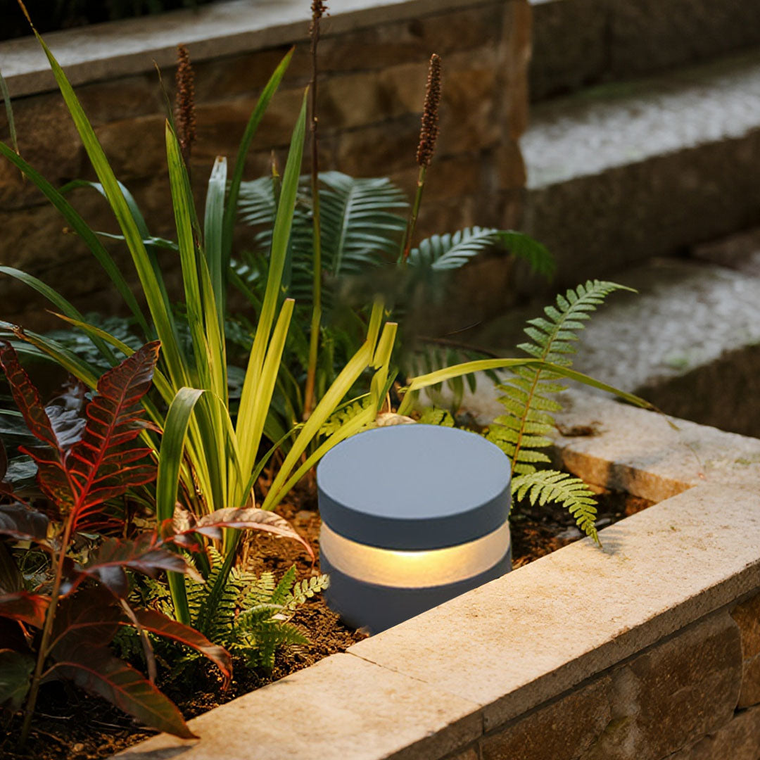 110v landscape light positioned near decorative plants creating elegant accent lighting for patio area