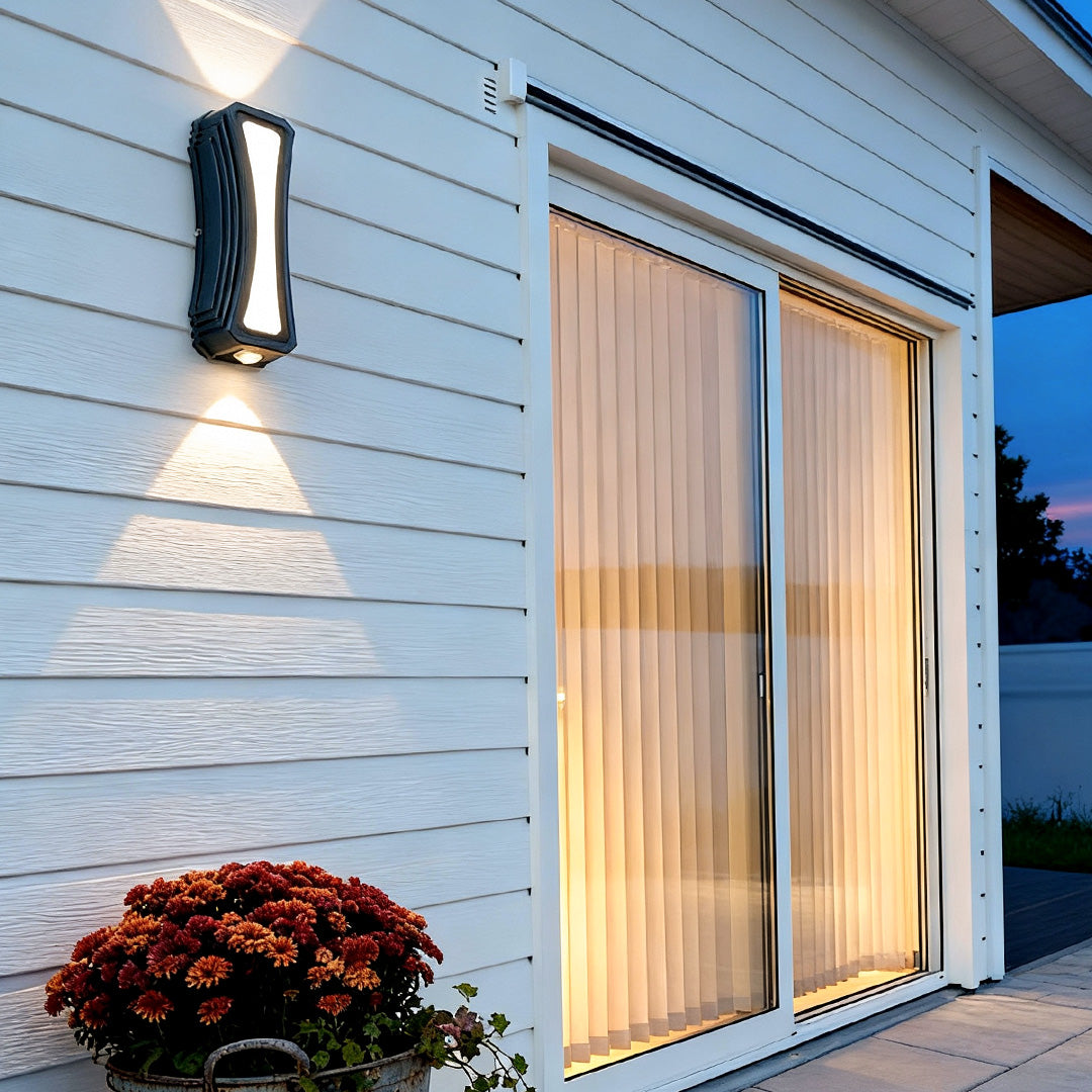 Modern up down outdoor wall lights on a patio wall creating bright vertical beams that enhance the outdoor living space.